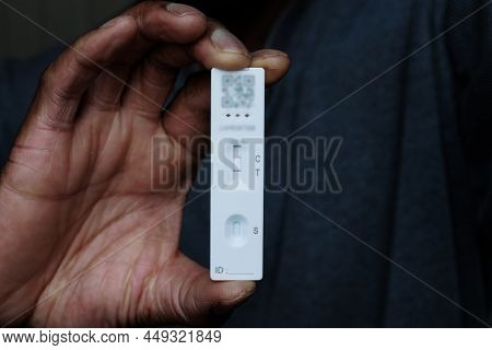 Person Of African Ethnicity Holding A Single Positive Covid-19 Rapid Home
