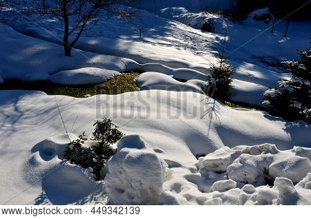 Large Layers Of Snow Covered The Gardens The Snow Is Melted Only At The Site Of The Creek. The Lawn 