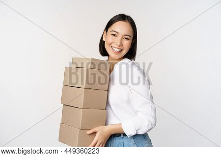 Portrait Of Young Asian Woman Holding Boxes, Carry Delivery Goods. Korean Female Entrepreneur Assemb