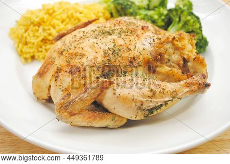 A Plated Whole Roasted Game Hen With Healthy Sides