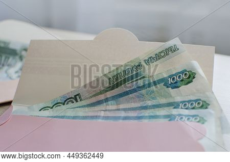 Banknotes Of Rubles, Cash Money In Envelope On White Background. Money Savings Concept.