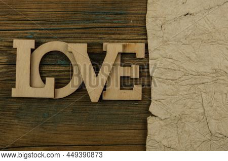 Love word, small hearts on dold woodr background. Top view of Valentine's Day. Copyspace.