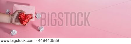 Hand Of Aggressive And Frustrated Man Squeezing Heart Out Of Crumpled Paper. Envelope With Lumps Of