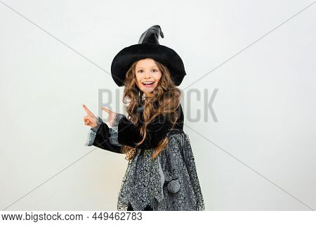 Dancing Enchantress With A Smile On Her Face. A Wizard On A White Background. A Little Girl In A Mag