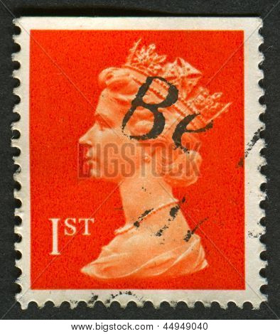 UK-CIRCA 1990:A stamp printed in UK shows image of Elizabeth II is the constitutional monarch of 16 sovereign states known as the Commonwealth realms, in red, circa 1990.