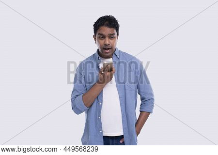 Indian Man Talking On Phone Standing Isolated. Angry Man Loudly Speaking On Phone Commecial, Shoppin