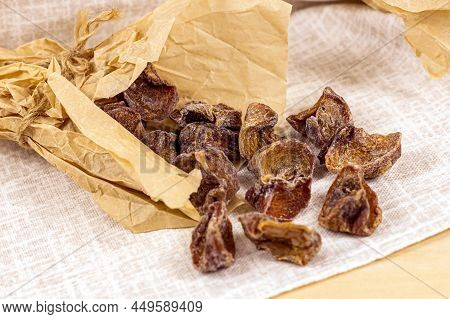 Traditional Japanese Hoshigaki Dried Persimmon Fruit Snack Slices In Wrapping Paper On Light Backgro