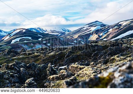 Pattern Of Snow Cover On The Mountain And Rough Hard Lava Rocky Ground At Landmannalaugar In Highlan