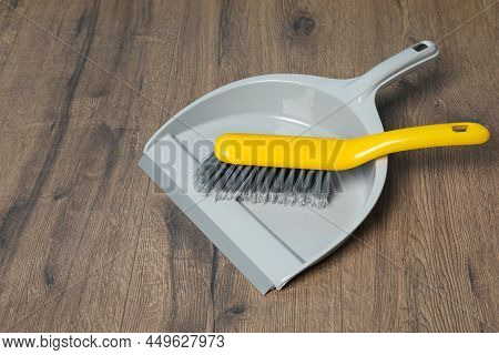 Plastic Whisk Broom With Dustpan On Wooden Floor