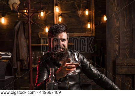 Man With Beard Holds Glass Brandy. Bearded Drink Cognac. Expensive Drink. Man In Shirt Drinking Bran