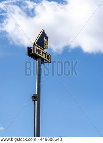 Wroclaw, Poland - February 19, 2022: A Column With Netto Food Store Logo. Blue Sky With Copyspace.