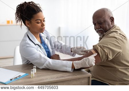 Senior Man Getting Vaccinated Against Covid, Doctor Applying Plaster