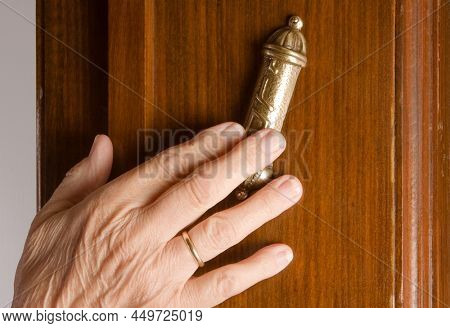 Jewish hand touching a mesusah on a door-post