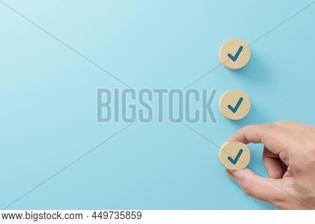 Checklist And Check Mark Concept. Check Mark On Wooden Blocks On Light Blue Background