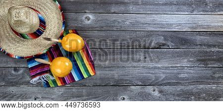 Mexico Cinco De Mayo Background With Large Sombrero, Serape And Maracas In Flat Lay View On Vintage 
