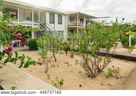 Typical White Local Wooden Village House Along Coastside In Placencia, Belize