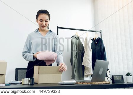 Asian Entrepreneur Is Preparing Her Clothes That Can Be Sold In Paper Boxes For Delivery To Customer