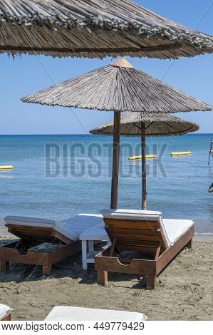 Beach Unbrellas And Chairs On Sunny Sandy Beach Lady's Mile In Akritori, Cyprus