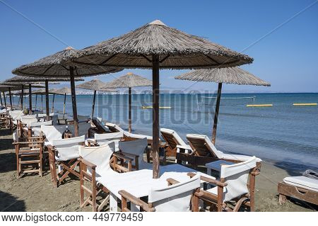 Beach Unbrellas And Chairs On Sunny Sandy Beach Lady's Mile In Akritori, Cyprus