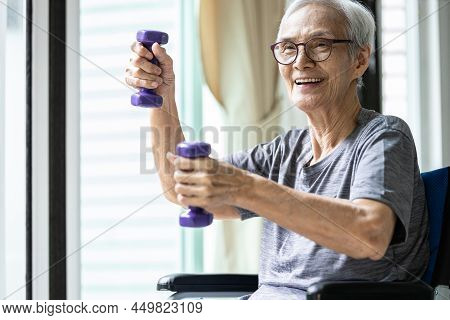 Strong Asian Senior Woman Working Out With Heavy Dumbbells,lifting Dumbbell Weights For Strength Tra
