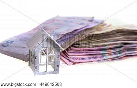 Uah Hryvnia Banknotes With Wooden House Isolated On White Background. Ukrainian Money. Concept Of Mo