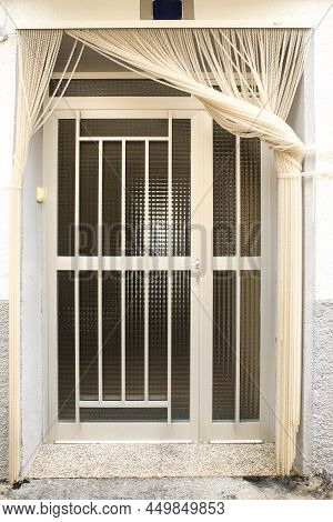 White Aluminum Door With Geometric Details And White Curtain
