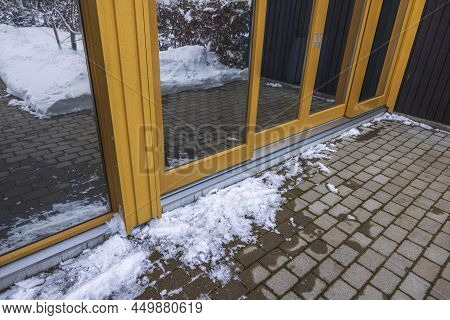 Exterior View Of Glass Wall Of Modern House And Icy Paving Slabs. Sweden.