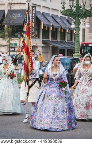 Valencia, Spain - 4 September 2021: Tradional Clothed Group Walking With Flag At The Celebration 'fa
