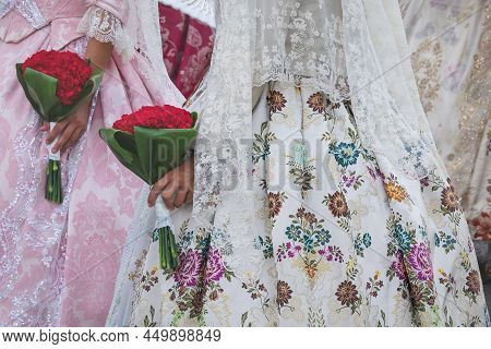 Detail Of Traditional Spanish Floral Dresses With Flower Offering At The Celebration 'fallas', Valen