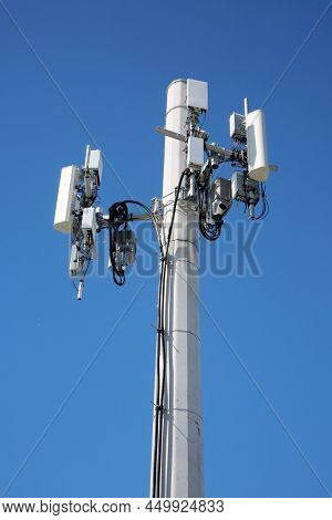 Cellular Telephone Tower. A cell tower carrying antennas of four cellular networks. Cell Phones connect to cell towers to transmit information and date world wide. 