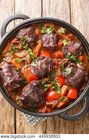Rabo De Toro Or Oxtail Stew In Cooking Pot Closeup On Plate On The Wooden Table. Vertical Top View F