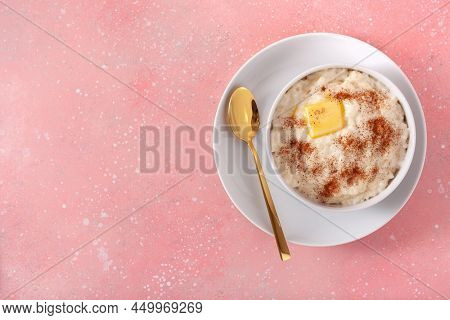 rice pudding with butter cinnamon. french riz au lait, norwegian risgrot, traditional breakfast dessert