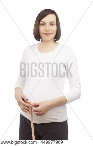 One Pregnant Brunette Woman Posing With Measurement Tape In White Shirt While Taking Dimensions Of H