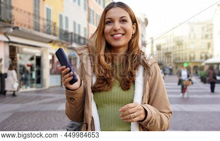 Panoramic Banner Of Confident Carefree Young Woman Walking In Pedestrian Street In Old Town Holding 
