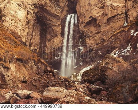 Waterfall Stream Flowing Down In A Massive Rocky Gorge Of The Caucasus Mountains