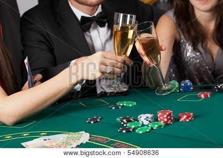 Friends In Casino Raising A Glasses