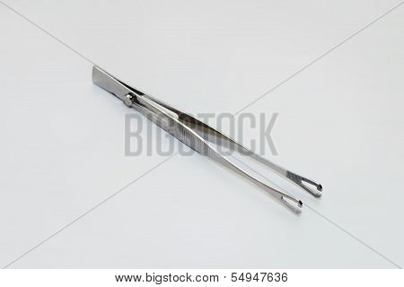 Tweezers With A Clamp
