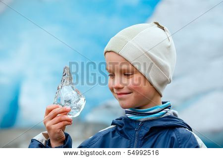 Boy With Ice Piece Near Nigardsbreen Glacier (norway)