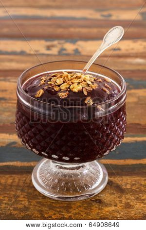 Acai In Glass With Muesli On Wooden Table. Vertical