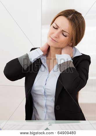 Young Attractive Businesswoman Suffer From Neck Pain