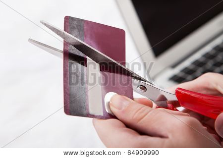Close-up Of Hand Cutting Credit Card