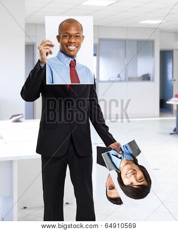 Man holding portraits of other people