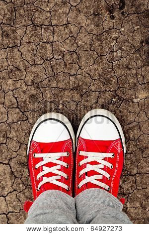 Boy In Red Sneakers Standing On The Ground, From Above