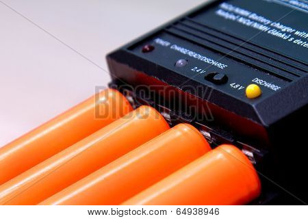Black Charger With Orange Battery