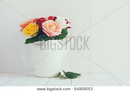 Colorful Roses In White Enamel Coffee Pot