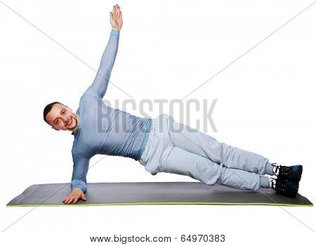 Muscular sportsman practicing yoga on a mat over white background