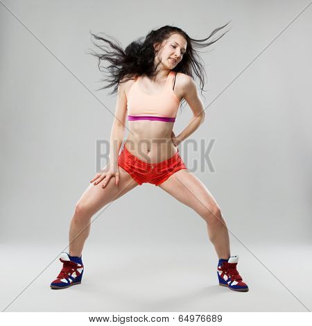 Professional dancer in studio on grey background