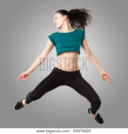 Professional dancer in studio on grey background