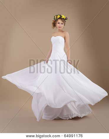 Beautiful Fiancee With Vernal Wreath Of Flowers In Flying Wedding Dress