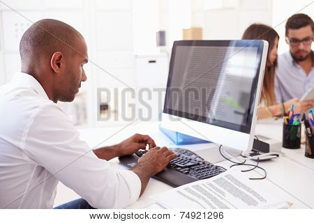 Businessman At Computer In Office Of Start Up Business